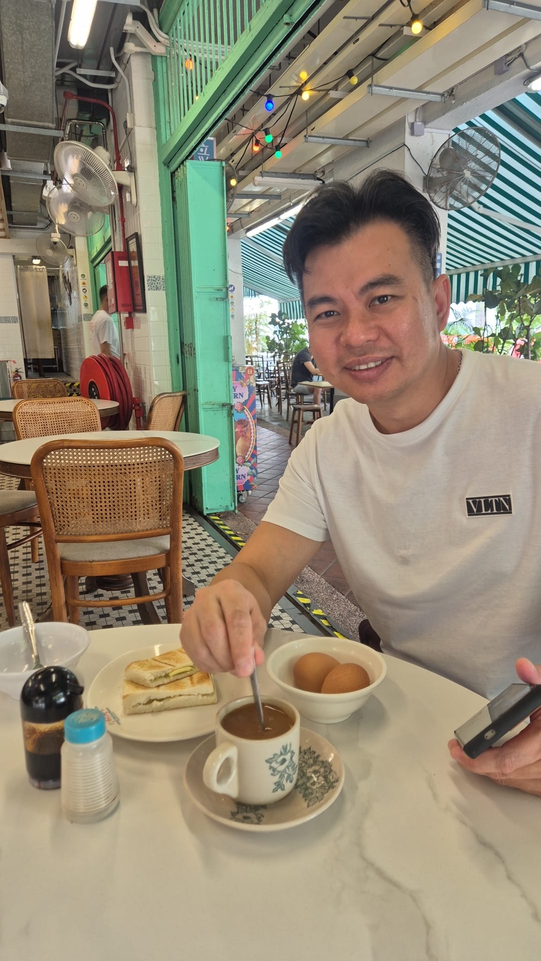 Boss Gerald having kopi and kaya toast at a neighbourhood kopitiam